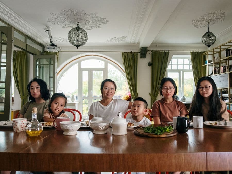 A household sharing a meal together around a large dining table.