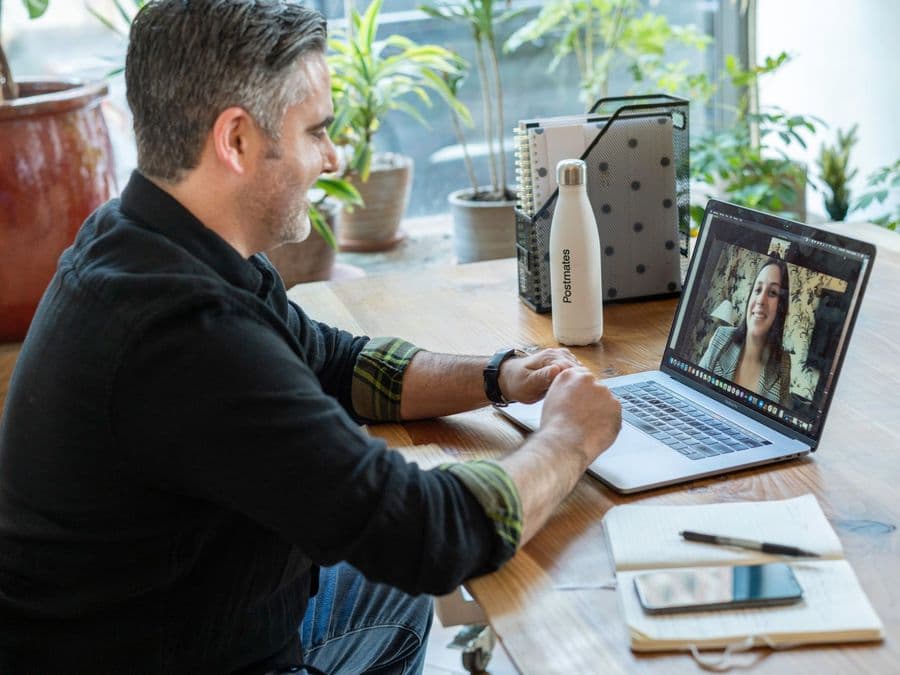 A man in a counselling session by video call from his own desk.